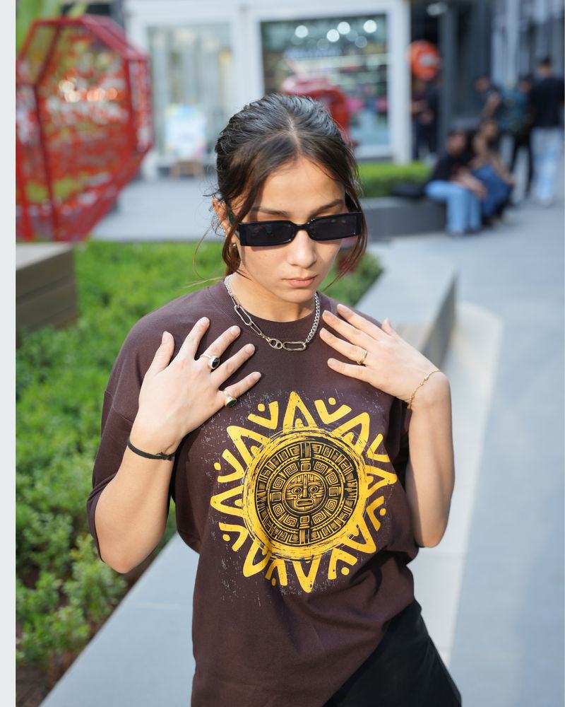 Model in a brown Golden Sun print tee
