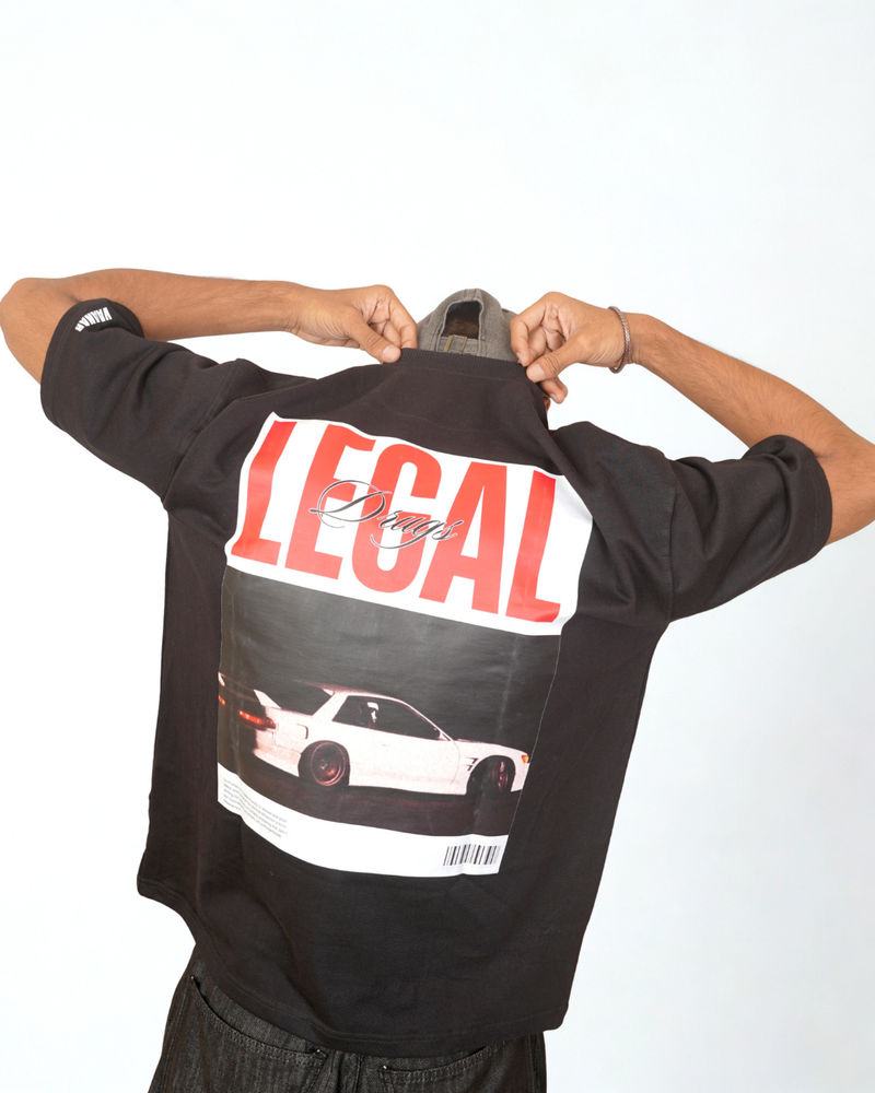 Model pulling on a black Legal Drugs tee